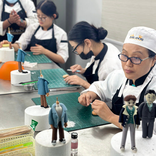Fondant figurine workshop with multiple students creating edible art decorations
