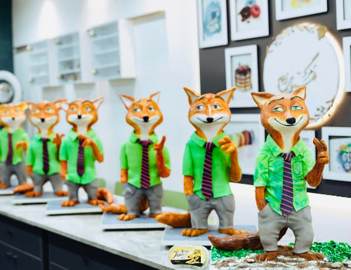 Learn structured cartoon cake design with sculpting, supports, and edible decorations