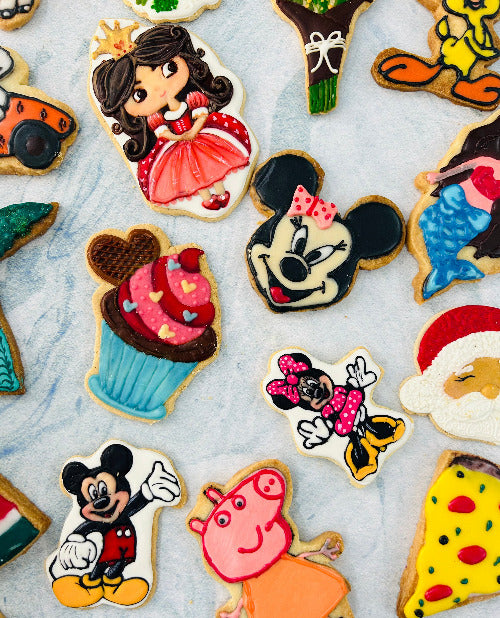 Students making royal icing cookies in a cookie decorating workshop